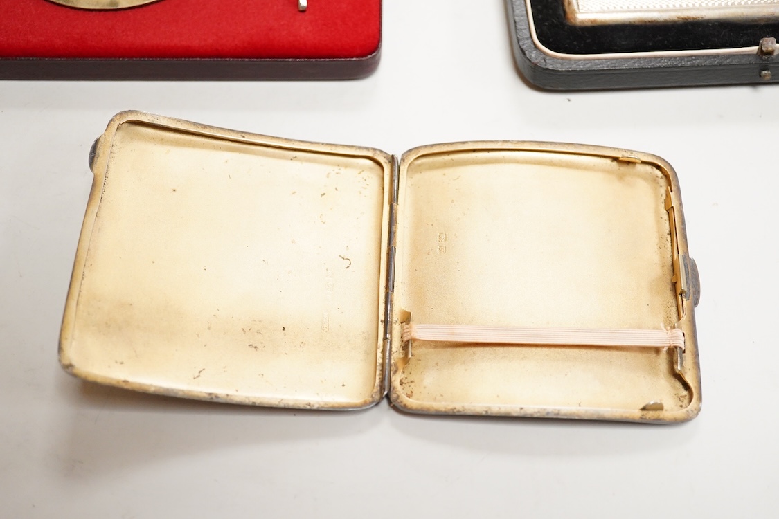 A cased engine turned sterling cigarette case, 11.4cm, a George V silver cigarette case and a cased commemorative limited edition silver gilt Churchill Centenary Picture Medal.